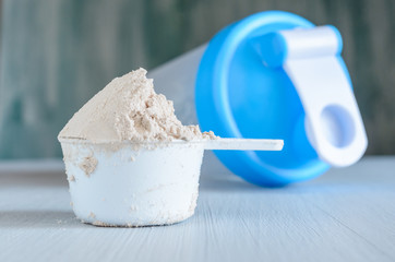 Scoop of protein and shaker. Sports nutrition.