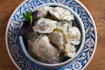 Dumplings stuffed with popato. Pierogi, varenyky, vareniki, pyrohy - dumplings with filling. Healthy vegetarian homemade food. View from above, top studio shot