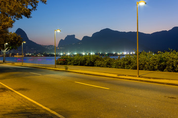 Fototapeta na wymiar Nocturne picture of Rio de Janeiro with light trails. Dois Irmaos and Pedra da Gavea. Lagoa, Rio de Janeiro, Brazil. 2017