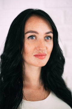 Portrait of brunette girl without retouching, visible skin problems