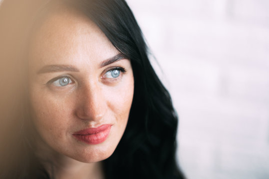 Portrait of brunette girl without retouching, visible skin problems