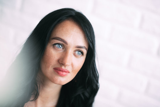 Portrait of brunette girl without retouching, visible skin problems
