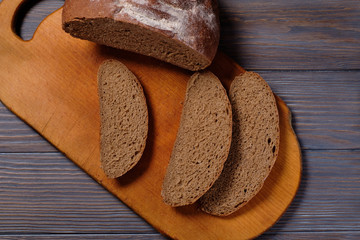Rustic bread loaf on dark background. Top view