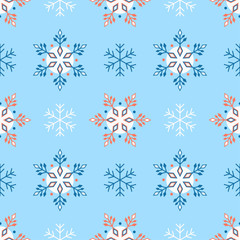 Seamless winter pattern with ornate snowflakes in red and white on a blue background.