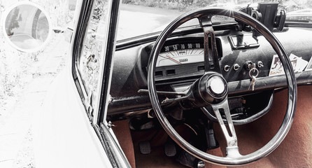 Road trip in a vintage car, close up of the steering wheel and dashboard. Vintage high key look and space for text.