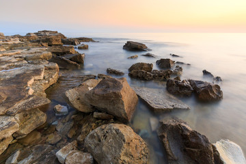 Enjoying the colorful sunset on a beach with rocks on the Adriatic Sea coast Istria Croatia