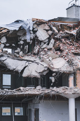 Building been torn down by the demolition team on a spring day