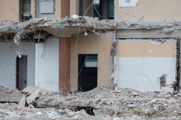 Building been torn down by the demolition team on a spring day