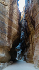 The Siq - narrow slot-canyon leading to the hidden city of Petra, Jordan
