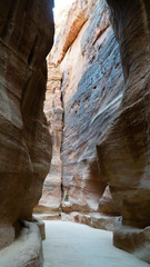 The Siq - narrow slot-canyon leading to the hidden city of Petra, Jordan