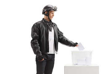 Young biker casting a vote into a ballot box