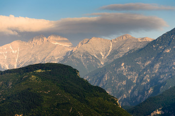 Landscape of the Olympus mountain range. View of a high rocky peaks in the distance and hillsides are covered with forest. It is highest mountains in Greece. National Park. World Biosphere Reserve.