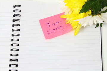 I am sorry Sticky Note handwriting message card with flower in white background