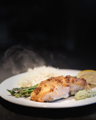 delicious meal prepared salmon in crust, black background