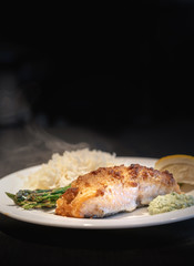 delicious meal prepared salmon in crust, black background