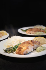 delicious meal prepared salmon in crust, black background