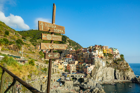 A directional sign pointing the way to various towns in Cinque Terre national park, Italy.