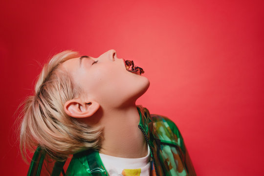 Young female with confetti in mouth