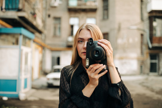 Female Photographer Holding An Plastic Instant Camera