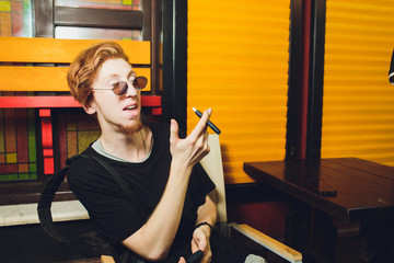 Smoker smoking hybrid smokeless cigarette device that uses real tobacco refills, a hybrid technology between analog and electronic cigarettes.