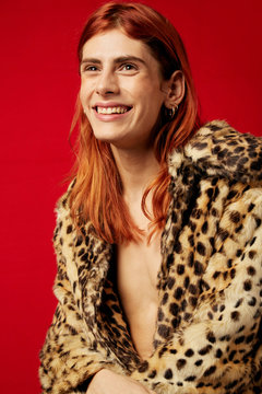 Smiling transgender beautiful woman over red
