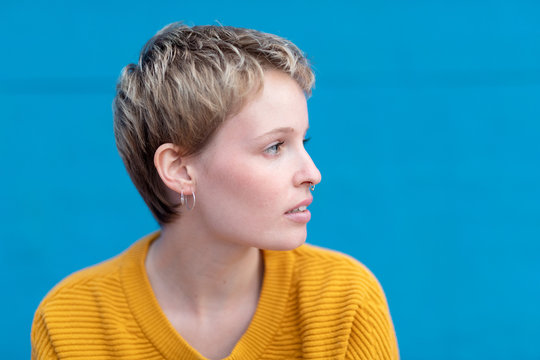 Pensive sensual girl with blonde hair and septum.
