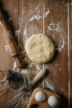 Dough near utensils and eggs
