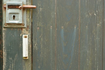 old green wooden door with lock on it