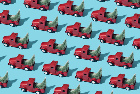 mosaic of red toy cars with christmas trees