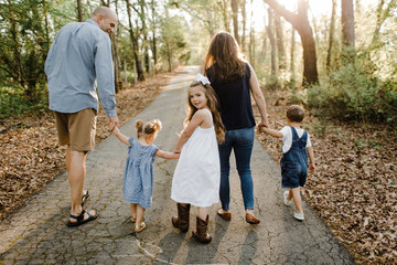 Family walking away, daughter looking back
