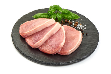 Fresh Pork loin steaks on a stone plate, isolated on white background