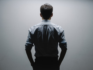 business man's back under light