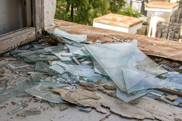 Broken glass on the window of an old house