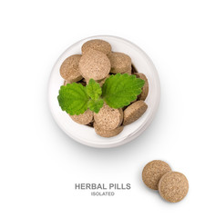 Isolate herbal pills in an open bottle.  Top view. Alternative supplement for good health. Flat lay. Phytotherapy. Рharmacological concept. Creative template for design, page layout.