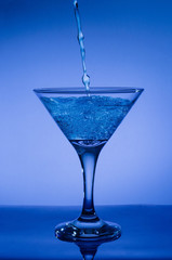 blue cocktail with splash isolated on white