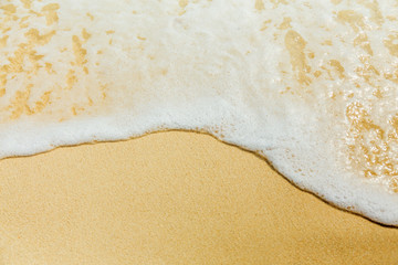 Sea surf, foam and sand