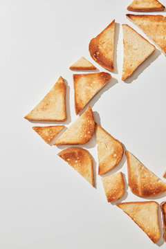 Corner frame of fried toast slices on a gray background with copy space. Food composition. Flat lay