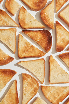 Various pieces of fried toast on a gray background with shadows. Food layout. Flat lay