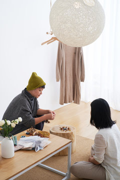 Asian women at home for family art activities