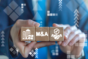 Merger and Acquisition Business Corporate Cooperation Company concept. M&Q partnership concept on wooden dices in businessman's hands.