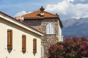 Old Town Budva, Montenegro. We see ancient houses, a very narrow street and great mountains