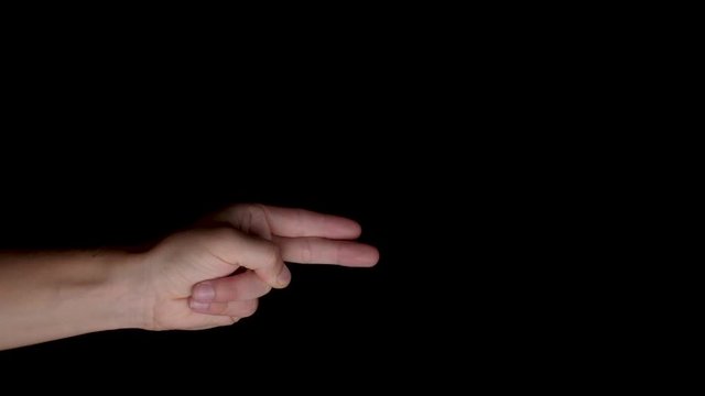 Hand symbol gesture of a pistol loading/firing and pulling back on a black backdrop