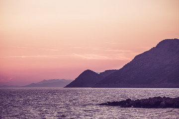 Sunset on the sea among the beautiful mountains, the Adriatic Sea. Montenegro.