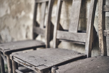 Blurred wooden vintage chairs background. Close up.