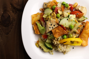 Tasty healthy dinner with chicken meat, fresh vegetables and rice, close up