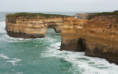 Fototapeta na wymiar Some cliffs with holes at the Great Ocean Road in Australia