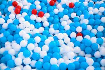 A kids pool full of plastic balls