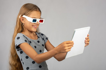 The girl is looking at the colored 3D glasses made using the anaglyph technology of 3D glasses