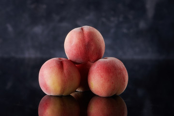 Fresh peaches on dark background
