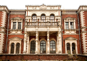 Fototapeta na wymiar Fragment of the Vorontsov-Dashkov Manor. The main entrance and the balcony. The village of Bykovo, Ramensky district, Moscow region,Russia. Old architecture. Brick building. Autumn view
